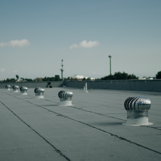 A commercial roof seen with roof-top vents.